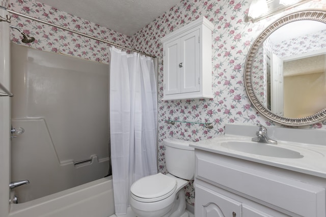 full bath featuring vanity, a textured ceiling, toilet, and wallpapered walls