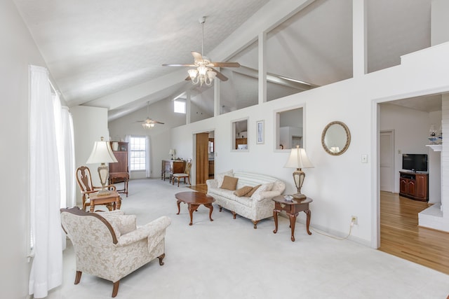 living area with baseboards, ceiling fan, carpet, high vaulted ceiling, and beam ceiling