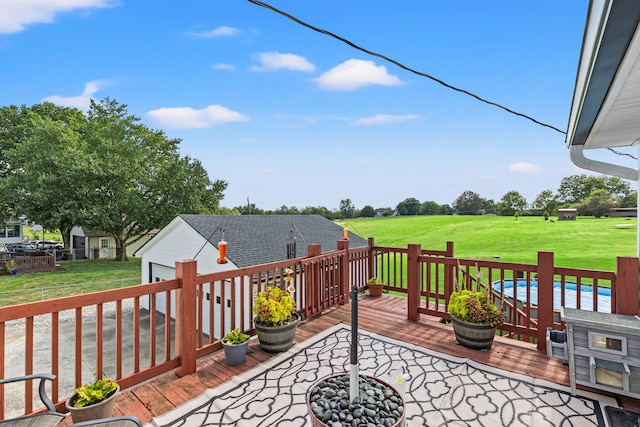 wooden deck featuring a yard and an outdoor pool