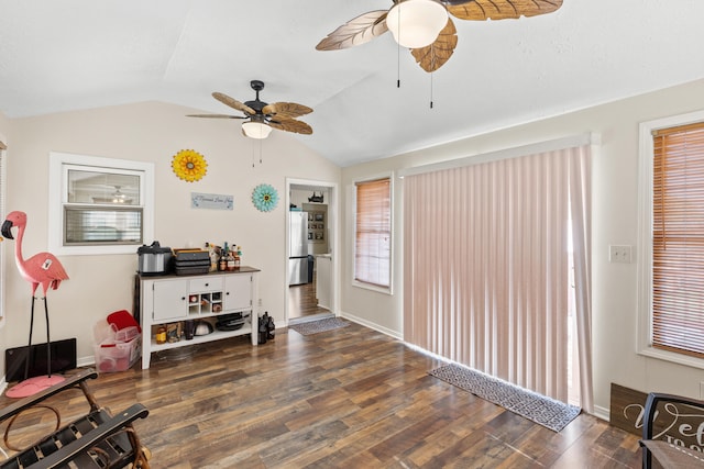 interior space featuring vaulted ceiling, wood finished floors, a ceiling fan, and baseboards