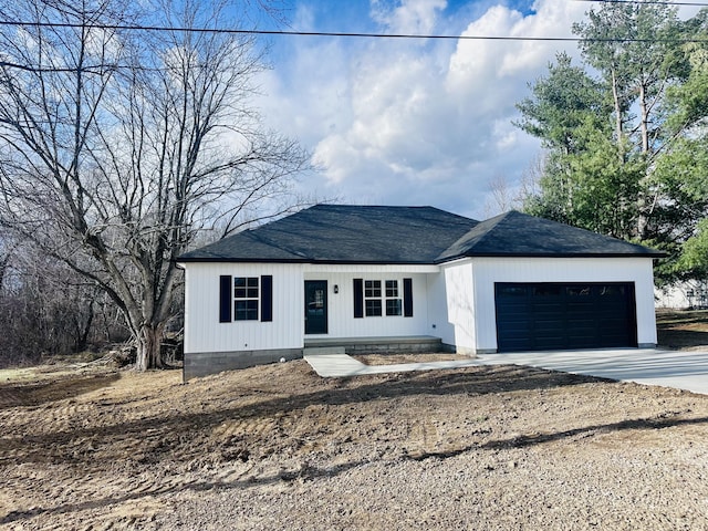 single story home featuring a garage, driveway, and a shingled roof