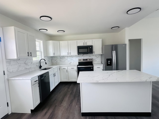 kitchen with decorative backsplash, white cabinetry, stainless steel appliances, and a sink