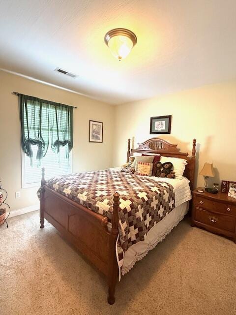 bedroom with carpet floors, baseboards, and visible vents