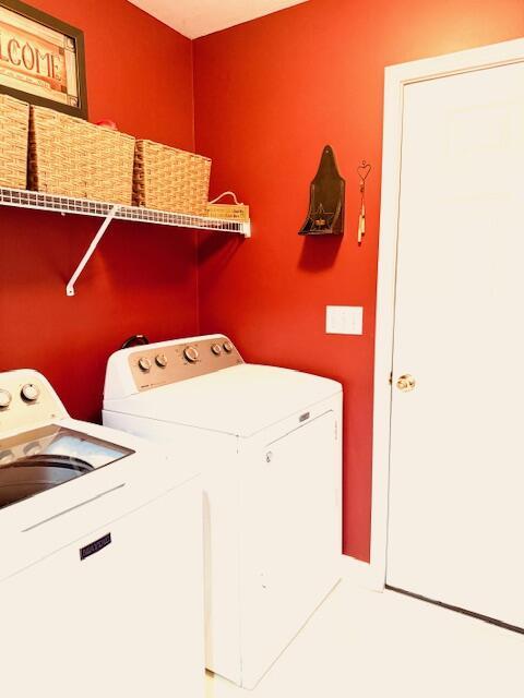 clothes washing area featuring laundry area and washing machine and clothes dryer