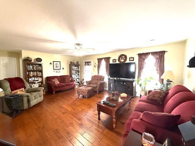 living room featuring ceiling fan and wood finished floors