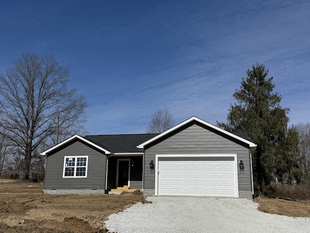 ranch-style home with gravel driveway, a shingled roof, and a garage