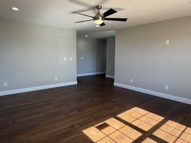 spare room featuring dark wood-style floors, recessed lighting, ceiling fan, and baseboards