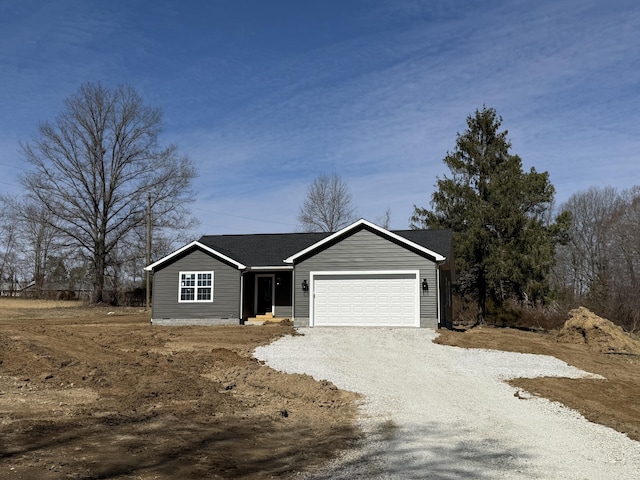 view of front of house featuring gravel driveway and an attached garage