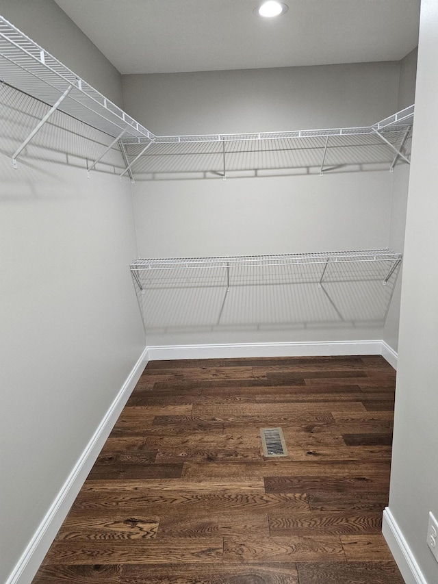 walk in closet with wood finished floors and visible vents