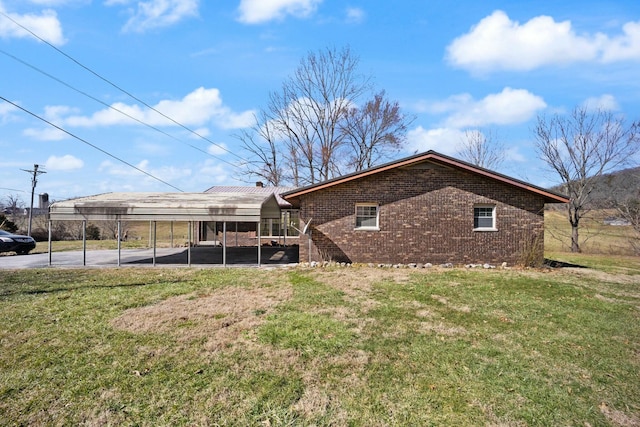 view of home's exterior featuring a lawn and brick siding