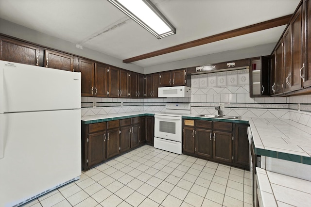 kitchen with tile countertops, white appliances, a sink, and dark brown cabinetry