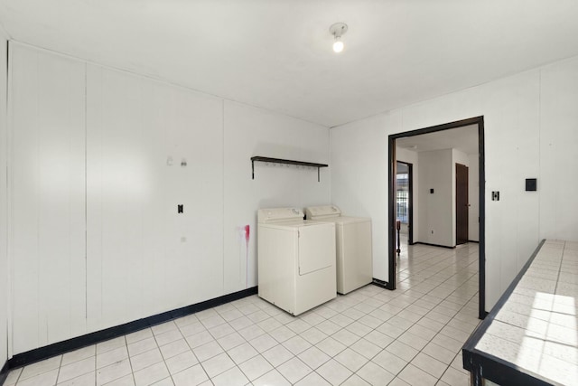 laundry area featuring light tile patterned floors, laundry area, and washer and dryer