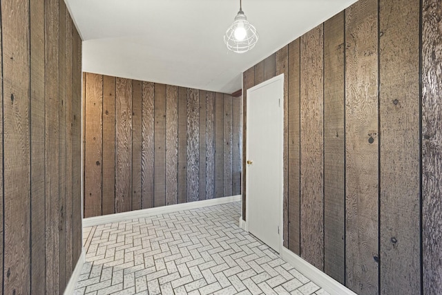 empty room featuring wooden walls