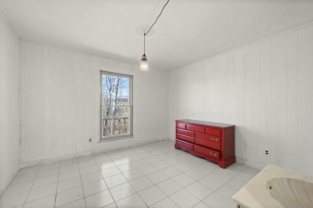 unfurnished room featuring light tile patterned floors and baseboards