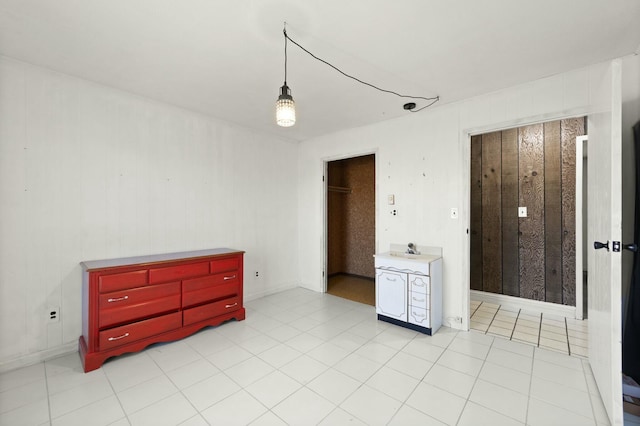 bedroom with a sink and light tile patterned flooring