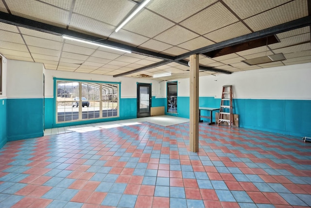 below grade area featuring wainscoting and tile patterned floors