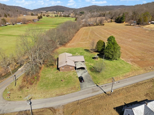 birds eye view of property with a mountain view and a rural view