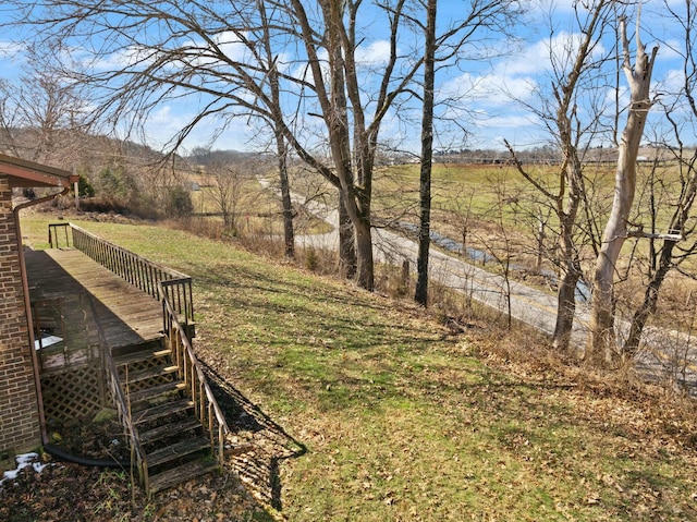 view of yard featuring stairway and a rural view