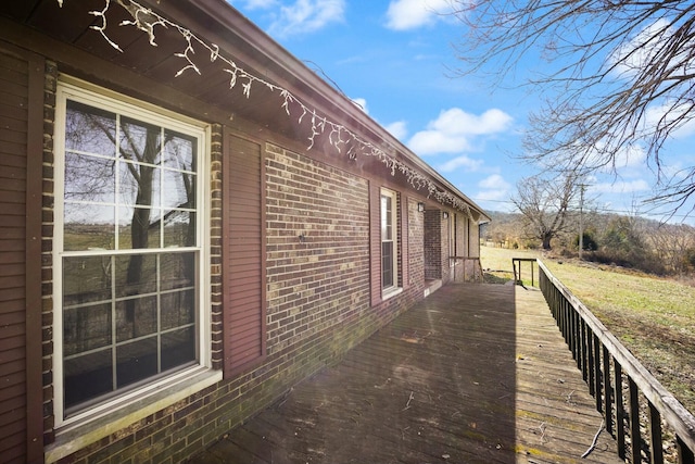 view of side of property featuring brick siding