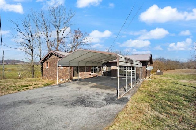 view of parking / parking lot with aphalt driveway and a detached carport