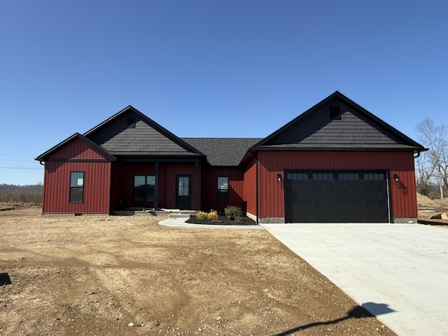 view of front of house featuring board and batten siding, crawl space, an attached garage, and concrete driveway