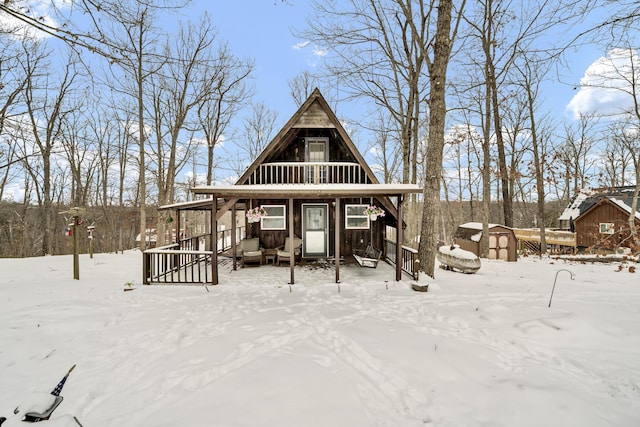 exterior space with a storage shed, board and batten siding, and an outbuilding