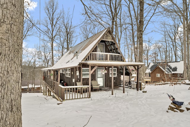 snow covered property with a deck