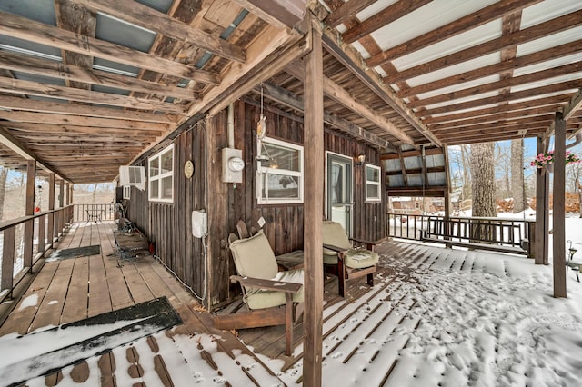 snow covered deck featuring a wall mounted AC