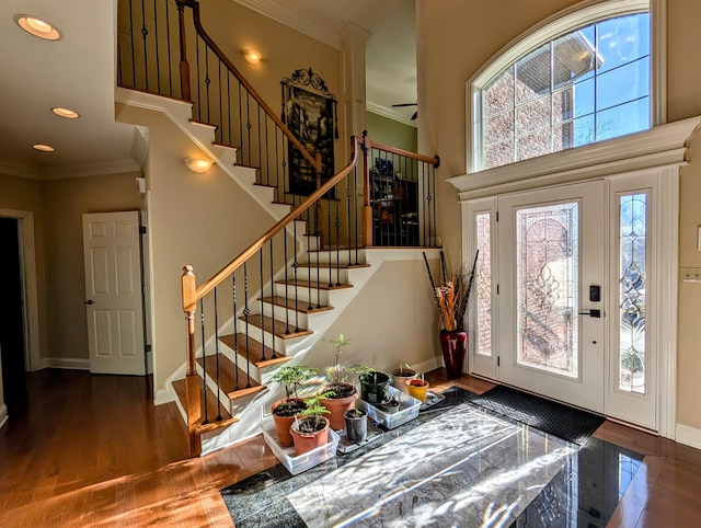 entrance foyer with ornamental molding, recessed lighting, baseboards, and wood finished floors