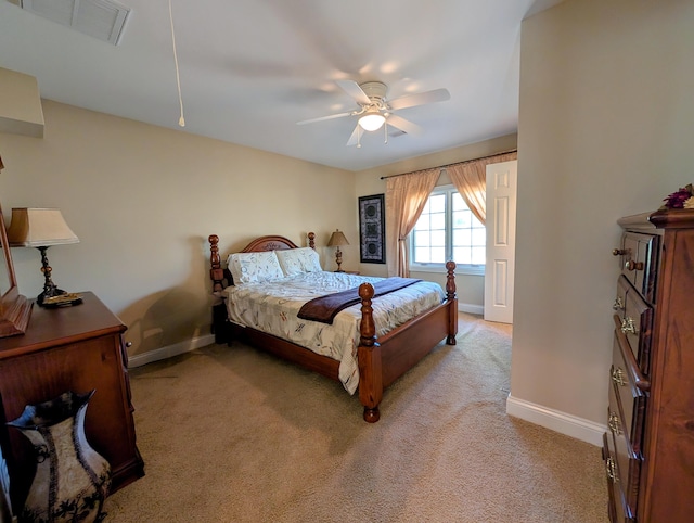 bedroom featuring light colored carpet, ceiling fan, visible vents, and baseboards