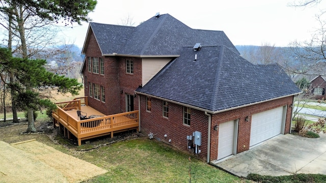 view of side of home with a garage, roof with shingles, concrete driveway, and brick siding