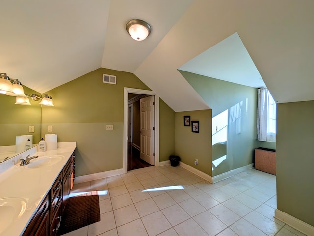 full bath featuring a sink, visible vents, vaulted ceiling, tile patterned floors, and double vanity