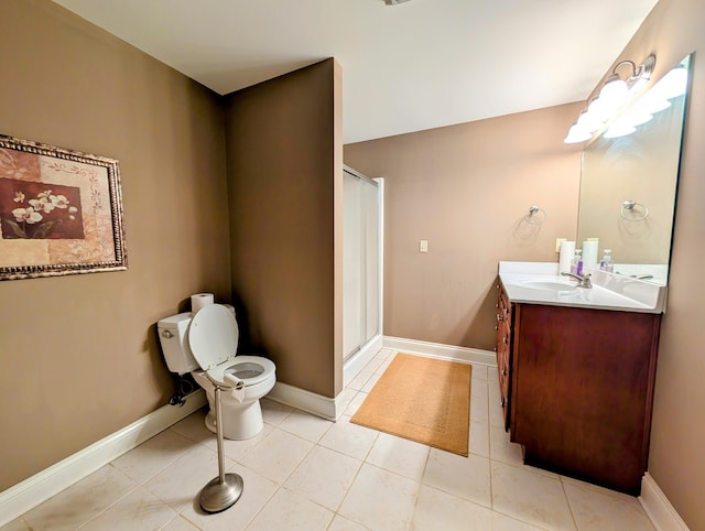 full bathroom with tile patterned floors, baseboards, a stall shower, and vanity