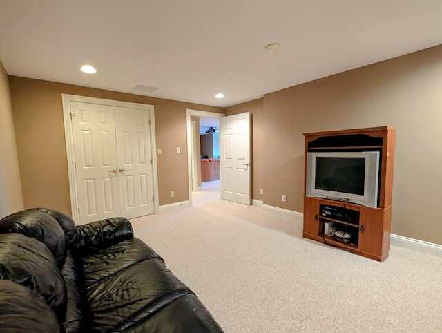 carpeted living area featuring recessed lighting and baseboards