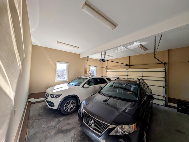 garage with baseboards and a garage door opener