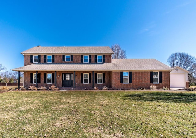 view of front of house featuring a front lawn, a porch, and brick siding