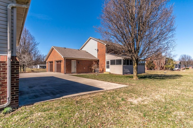 view of yard with a garage and a sunroom