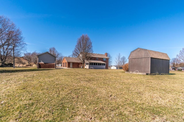 view of yard featuring a barn and an outbuilding