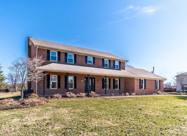 view of front of house with a front lawn and brick siding