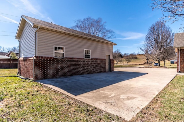 view of property exterior featuring a yard and brick siding