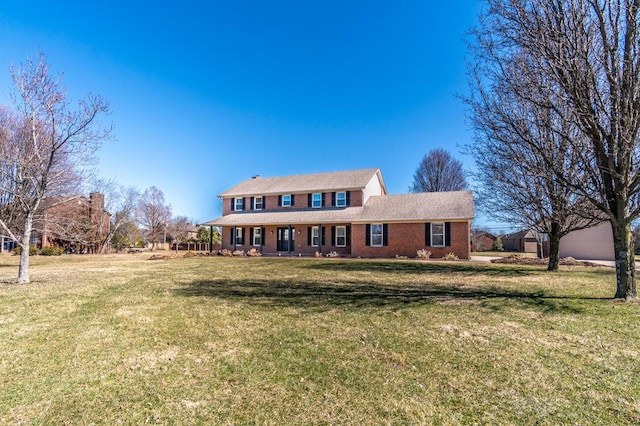 view of front of home featuring a front lawn and brick siding