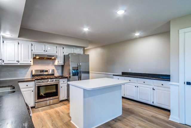 kitchen featuring light wood-type flooring, under cabinet range hood, appliances with stainless steel finishes, and white cabinets