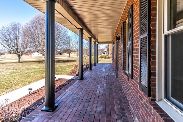 wooden terrace with a lawn and a patio