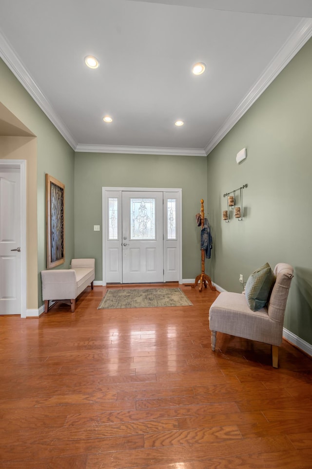 entrance foyer with crown molding, baseboards, wood finished floors, and recessed lighting