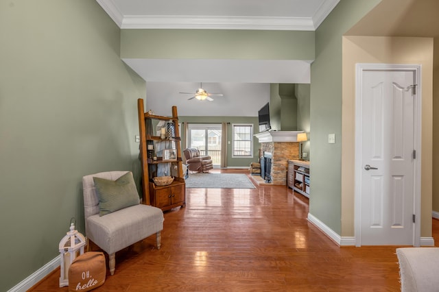 interior space featuring ceiling fan, ornamental molding, wood finished floors, and baseboards