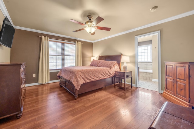 bedroom featuring ornamental molding, wood finished floors, and baseboards