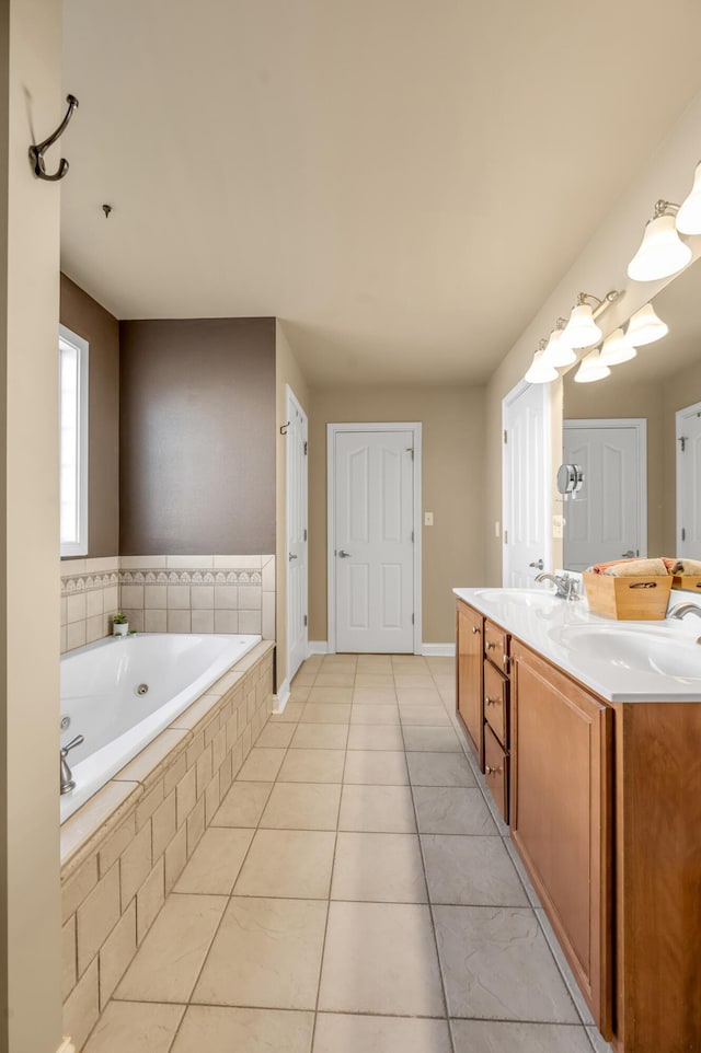 full bath featuring a bath, tile patterned flooring, double vanity, and a sink