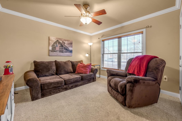 carpeted living area featuring ornamental molding, baseboards, and a ceiling fan