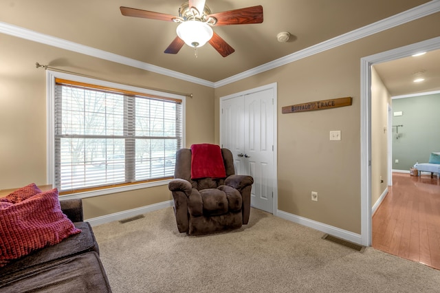 sitting room featuring ornamental molding, visible vents, and baseboards