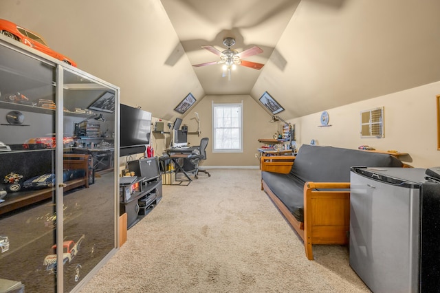 carpeted home office featuring lofted ceiling, baseboards, and a ceiling fan